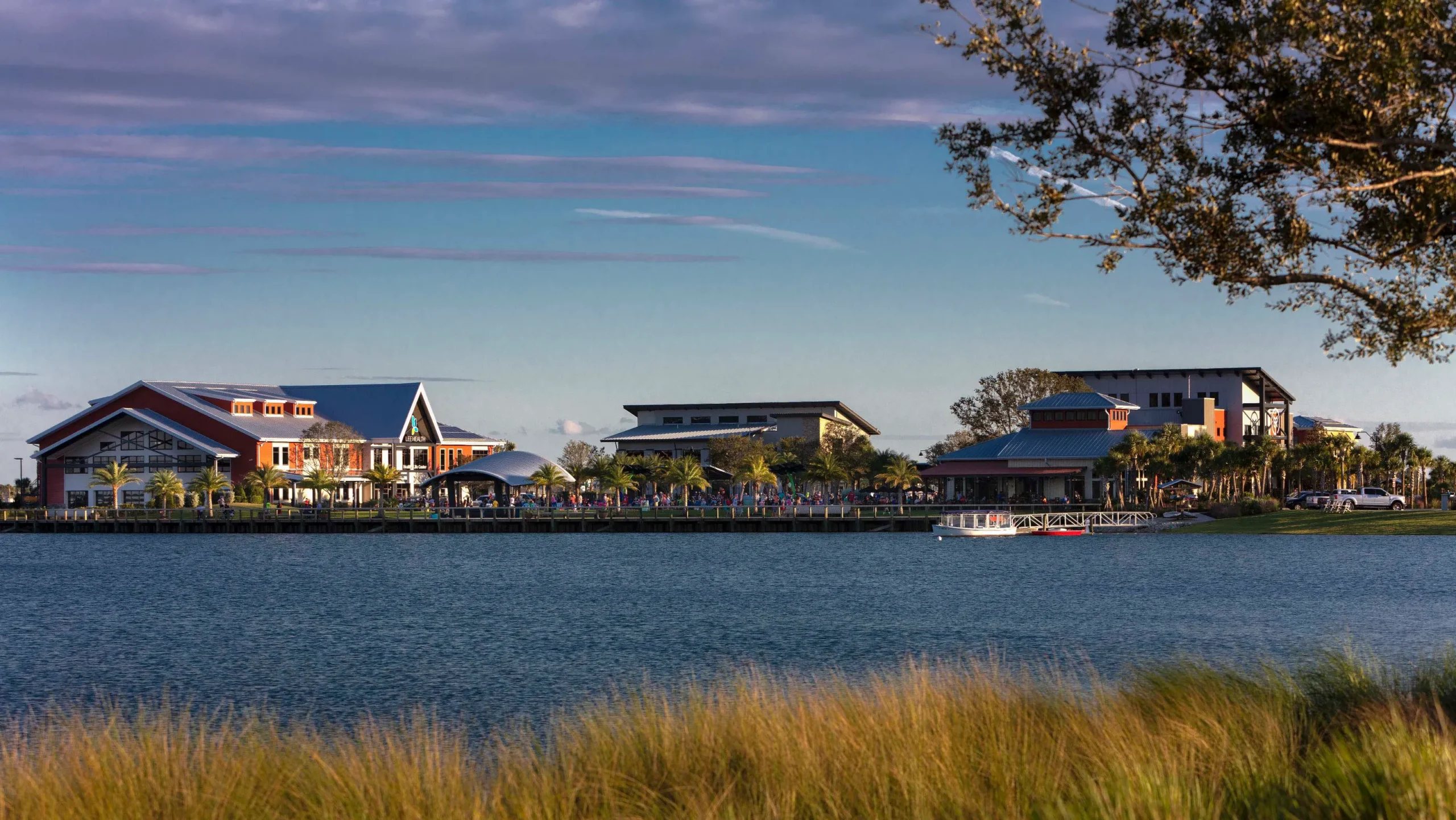Babcock Ranch waterfront with blue-roof buildings and palm trees